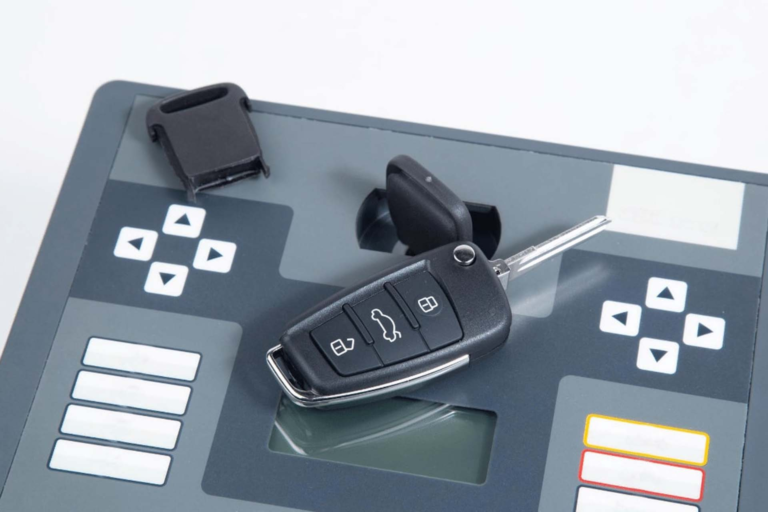 A car key fob kept on the car key programming tool